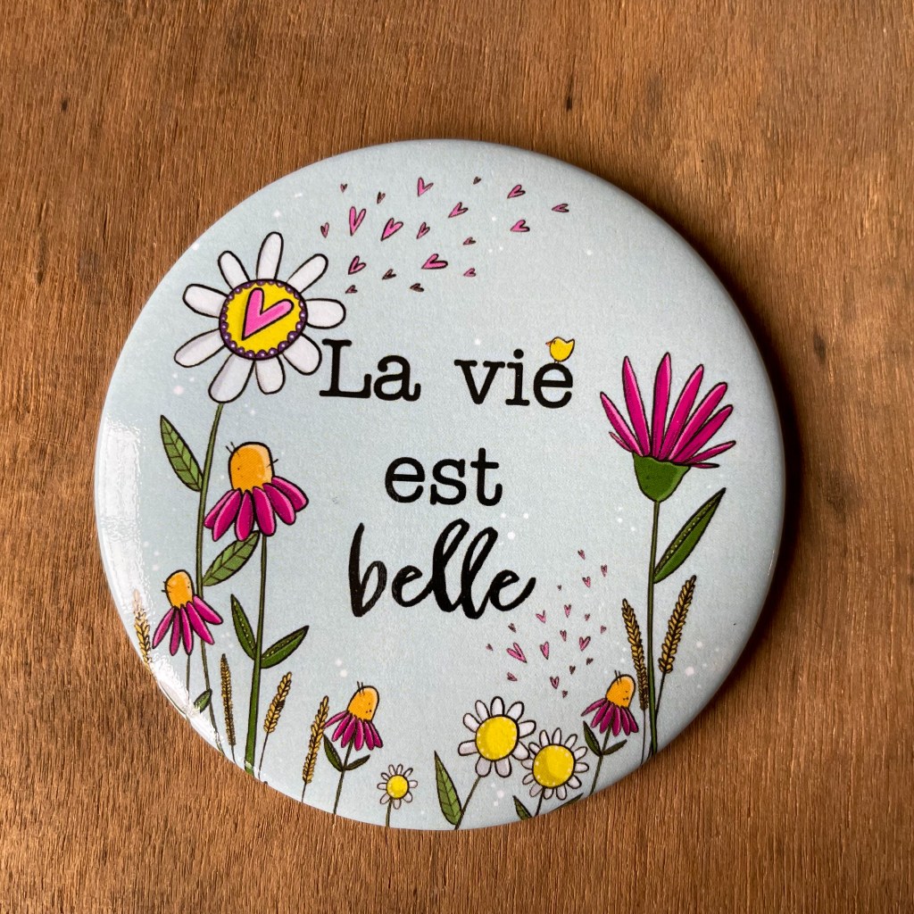 Aimant rond 3 pouces avec dessins de fleurs et de coeurs et l'inscription:"La vie est belle".